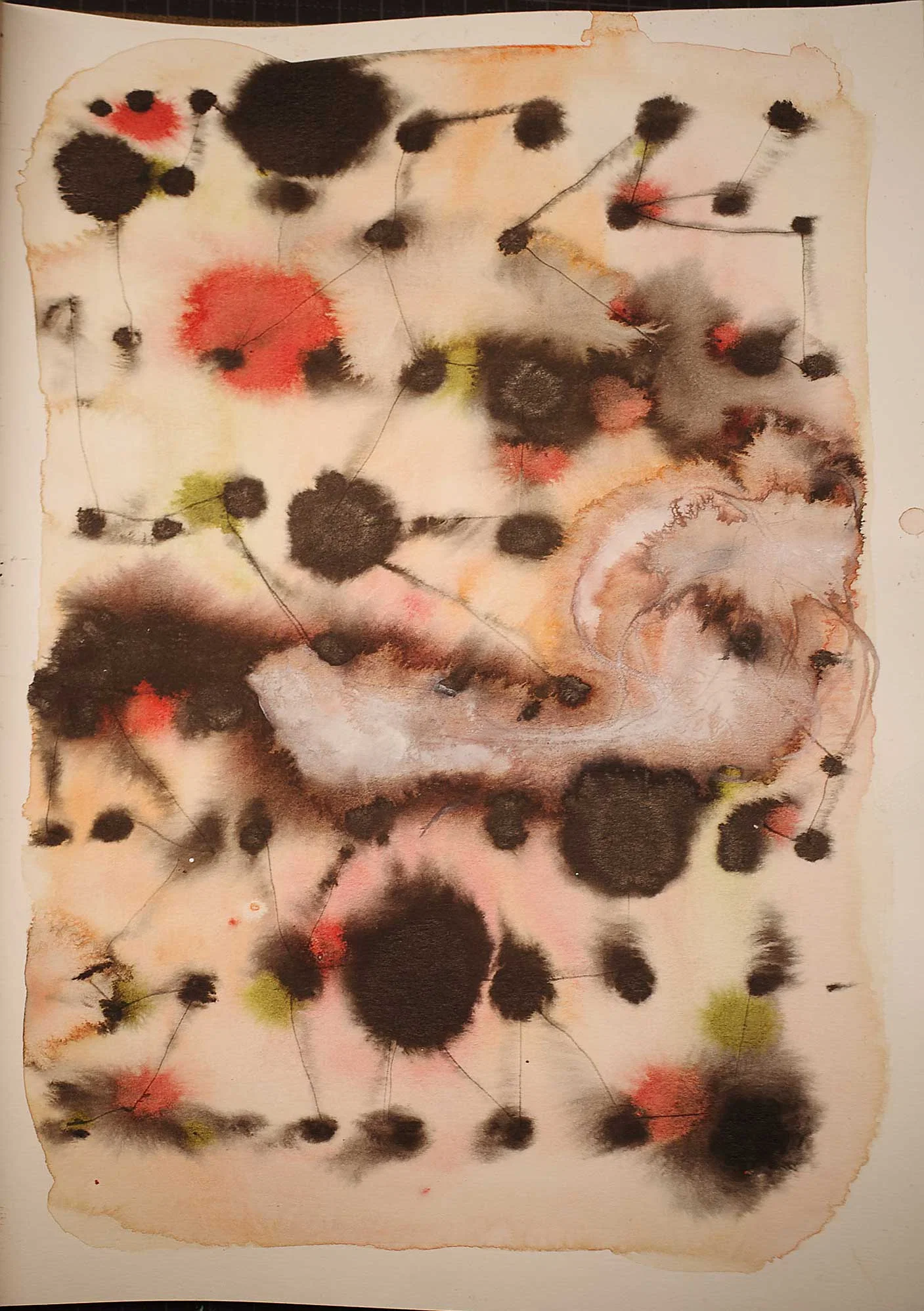 Numerous soft-edged black ink spots of different sizes are scattered across a pale background with muted red, yellow and green washes. Fine lines connect several of the spots, while a large pale, swirling form occupies the right-centre of the page.