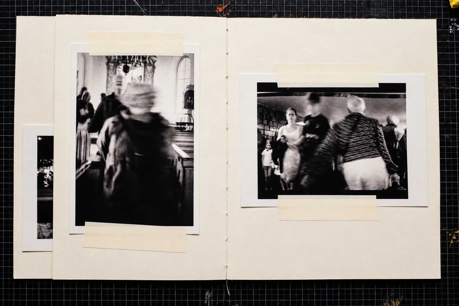 Two black-and-white photographs. On the left, a blurred person in dark clothing stands among wooden pews in a church interior. On the right, several people move through an indoor space, including a figure seen from behind in a striped jacket.