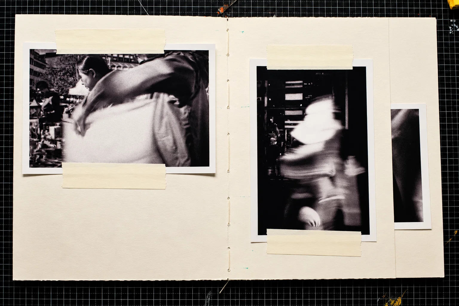 Two black-and-white photographs. On the left, a person in profile is partly obscured by a large, blurred foreground figure in an outdoor crowd. On the right, a passing figure appears as a pale blur against a dark interior.